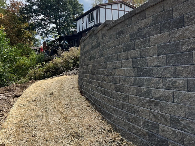 concrete block retaining wall on hillside stabilizing slope near home in Cincinnati Ohio