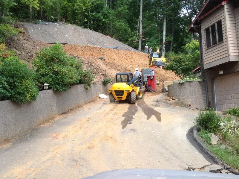 hillside stabilization construction with excavation and retaining wall installation in Cincinnati Ohio