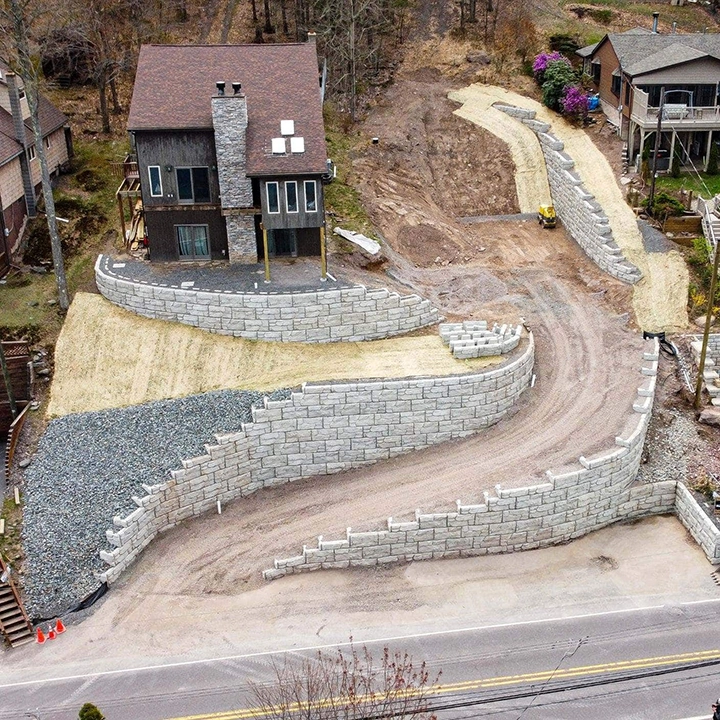 tiered retaining wall system stabilizing steep hillside near home in Cincinnati Ohio with multiple structural walls