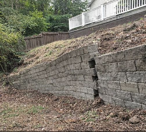leaning retaining wall with visible bowing and shifting blocks in Cincinnati Ohio