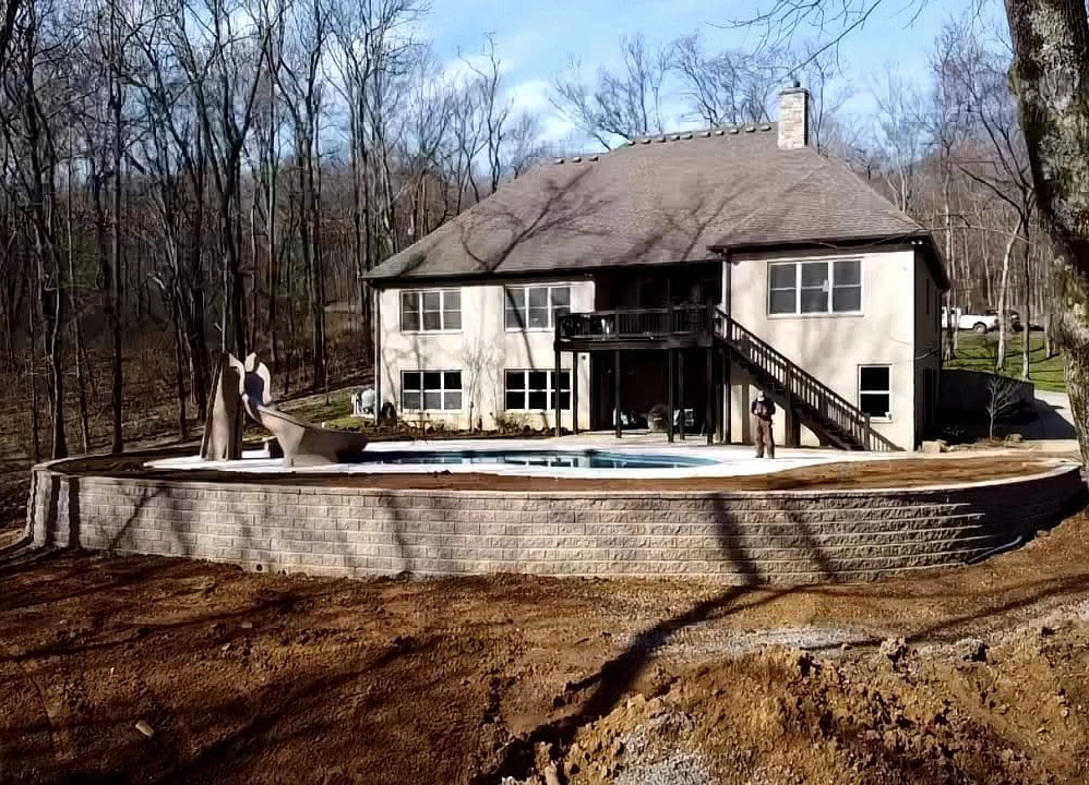 new retaining wall construction supporting backyard and pool area near home in Cincinnati Ohio