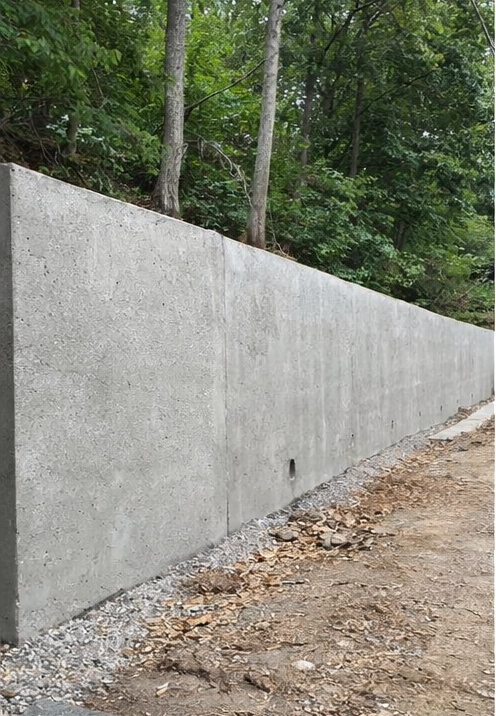 large structural concrete retaining wall holding back hillside soil in Cincinnati Ohio