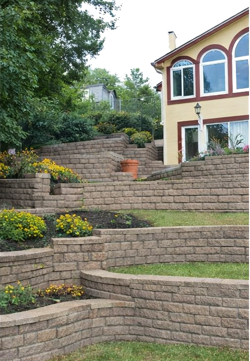 tiered retaining wall system with multiple levels stabilizing hillside near home in Cincinnati Ohio