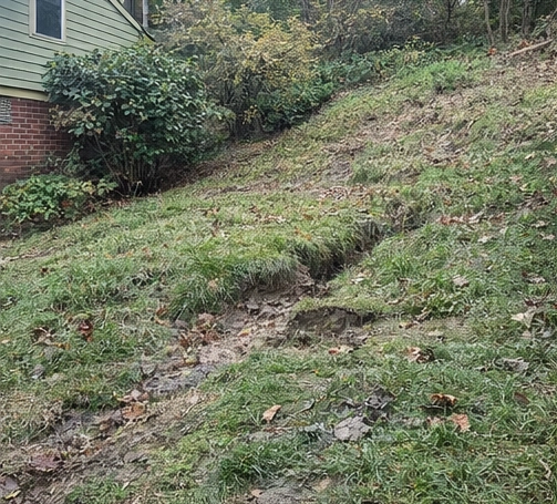 uneven hillside with sinking ground and dips in yard near home in Cincinnati Ohio