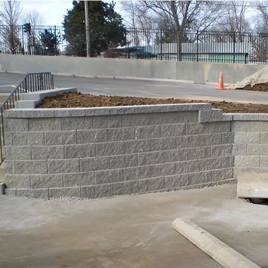 newly installed commercial block retaining wall supporting parking lot and staircase in Cincinnati Ohio