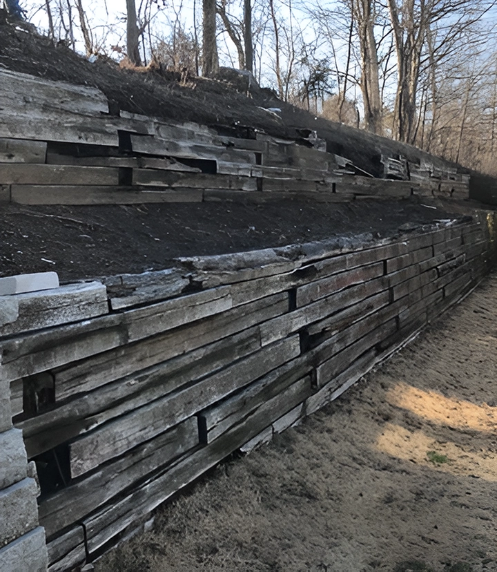 Rotting timber retaining wall with large gaps and separation showing structural failure in Cincinnati property