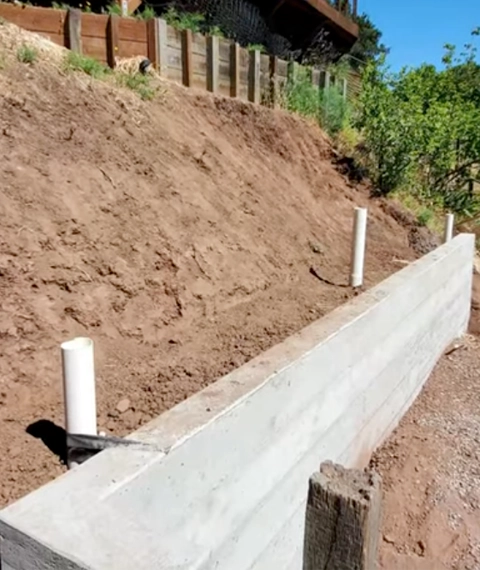 Hillside stabilization project in Cincinnati with excavation and retaining wall construction on a steep slope