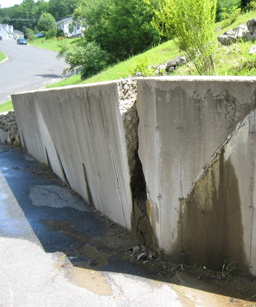 Water buildup behind retaining wall in Cincinnati causing soil saturation and structural pressure